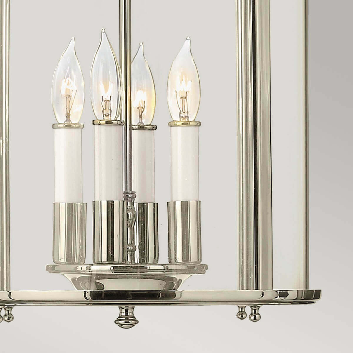 Détail des quatre bougies blanches et ampoules flamme dans la cage vitrée
