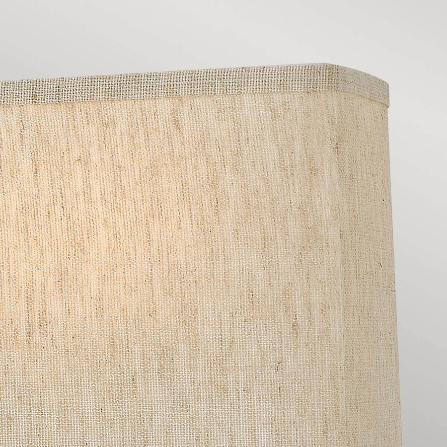 Gros plan sur l'angle de l'abat-jour en toile de lin tissée beige clair