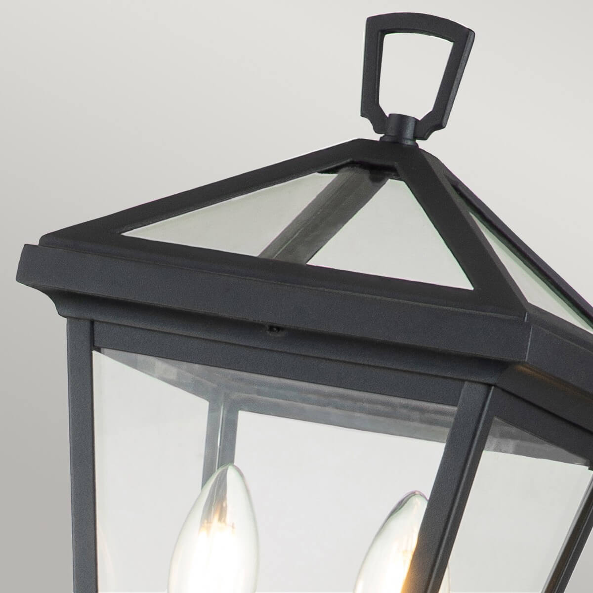 Détail du sommet : chapeau noir à arêtes et anneau de préhension au-dessus de la lanterne.