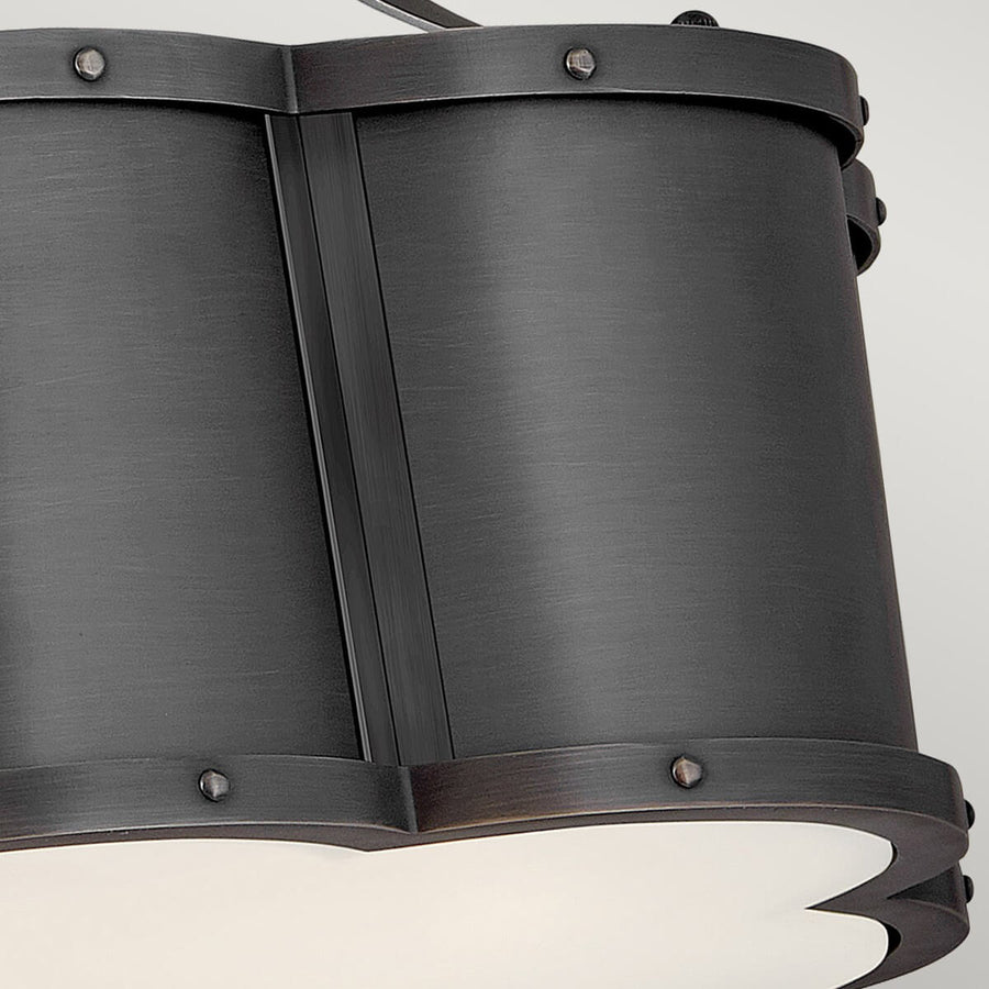 Détail du corps métallique sombre, rivets apparents et panneaux cintrés assemblés