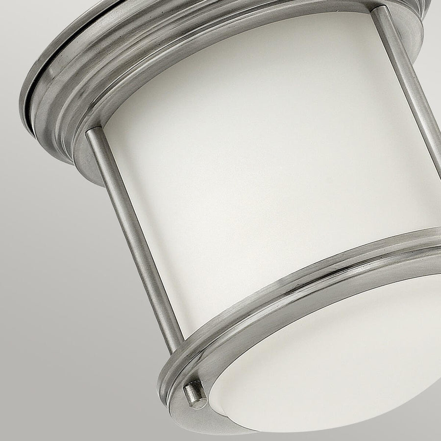 Détail rapproché du verre blanc et des tiges verticales en métal brossé