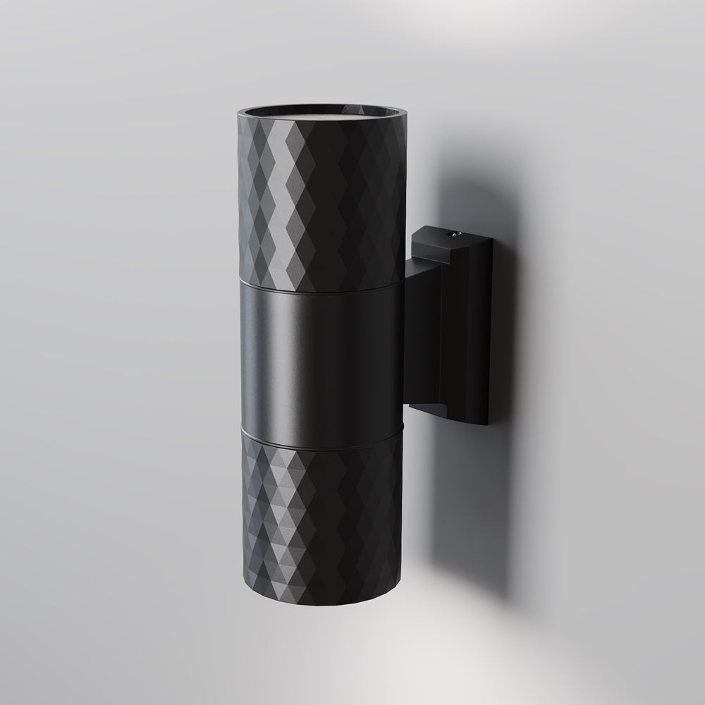 Applique murale noire cylindrique fixée au mur, éclairant vers le haut et le bas