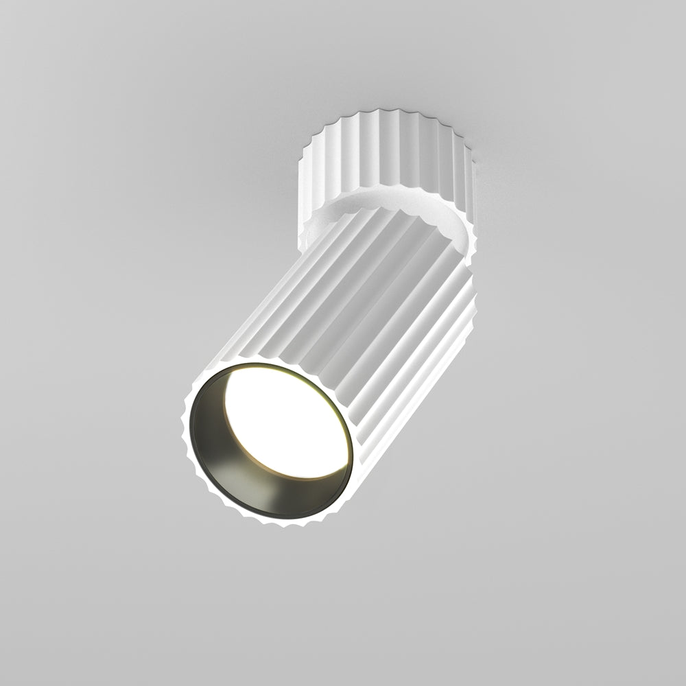 Vue de face d'un spot blanc orientable au corps cylindrique nervuré