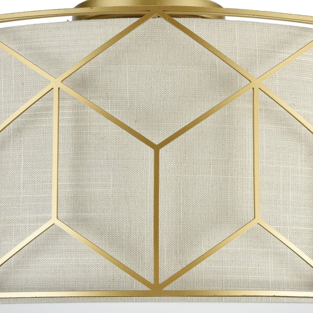 Détail rapproché de la finition dorée et de la texture tissée de l'abat-jour cylindrique.