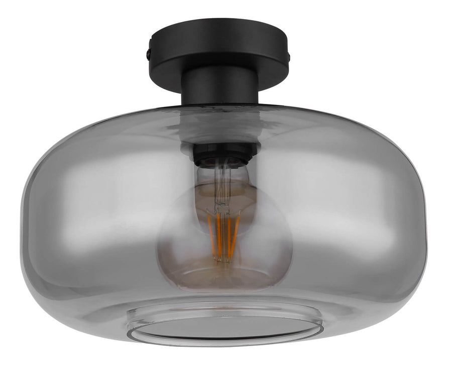 Vue rapprochée du globe en verre fumé et de l'ampoule filament dorée allumée