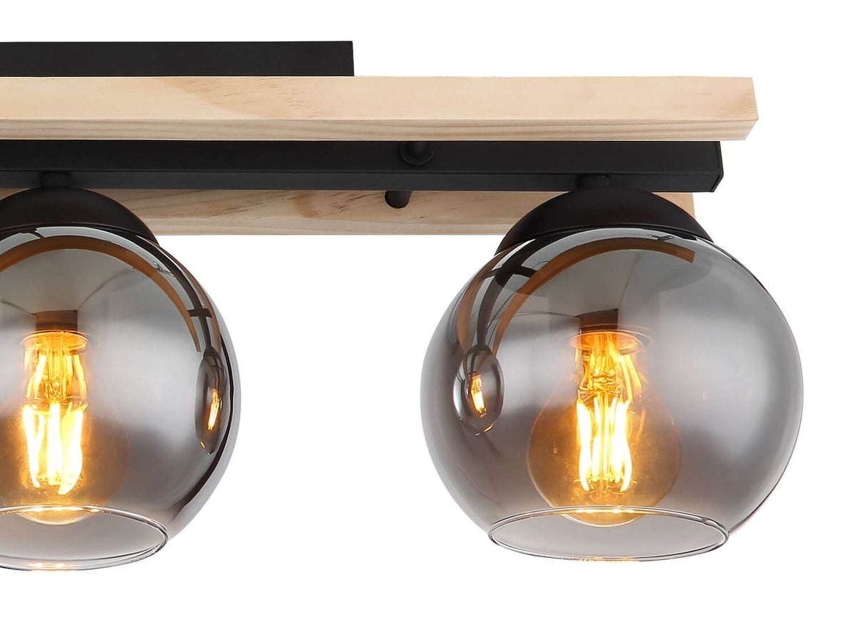 Détail rapproché de deux globes en verre fumé et de la finition bois