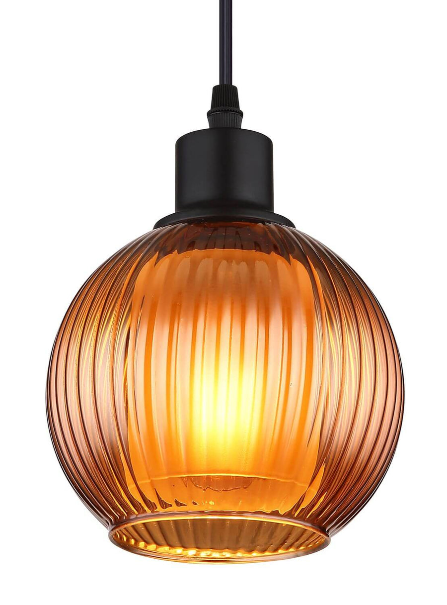 Gros plan du globe en verre ambré côtelé et de la douille noire mate.
