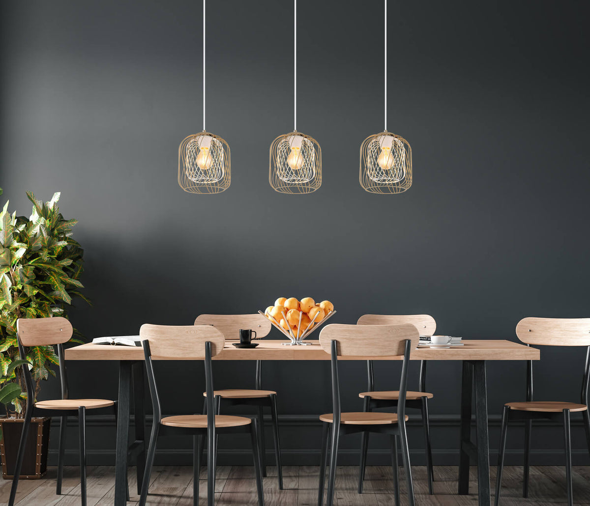 Mise en ambiance salle à manger sombre, trois suspensions cage dorée au-dessus table bois
