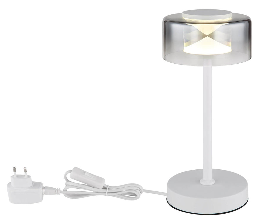 Lampe blanche avec câble d'alimentation, prise et interrupteur sur fond blanc.