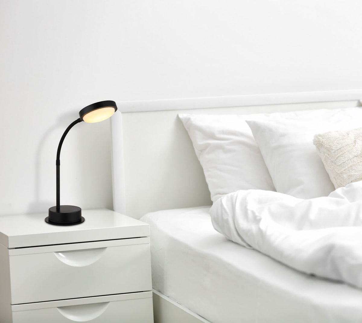 Mise en ambiance de la lampe posée sur une table de nuit blanche près du lit