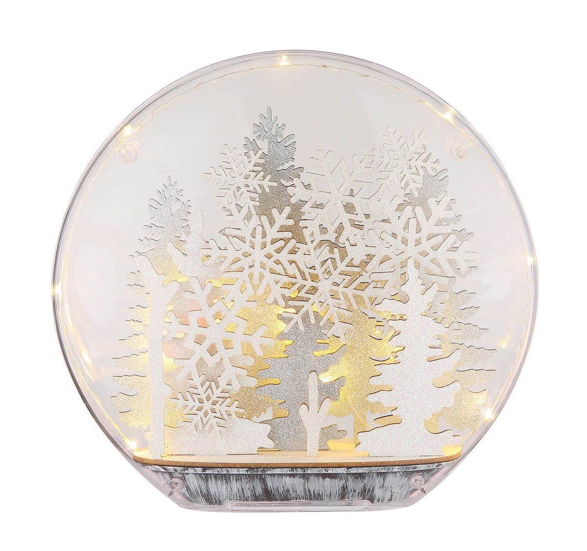 Autre angle de la lampe allumée, mettant en valeur la lumière chaude et les découpes hivernales.