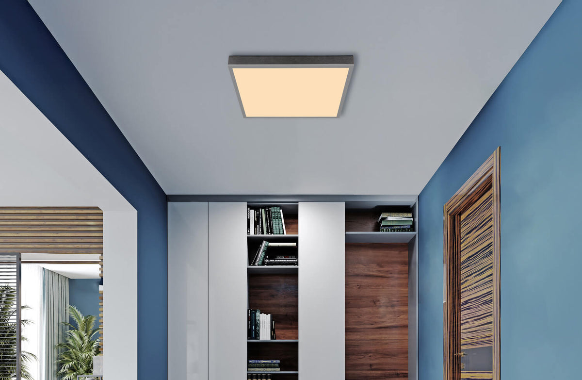 Mise en ambiance : plafonnier carré fixé au plafond dans un intérieur bleu et bois.