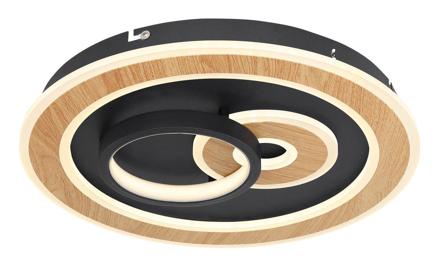 Gros plan du luminaire montrant les anneaux concentriques en bois et le module LED central.