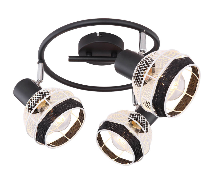 Luminaire vu de trois quarts, structure circulaire noire et diffuseurs ajourés aux reflets chauds