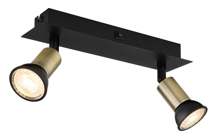 Second angle du luminaire, montrant la barre noire et les deux têtes cylindriques en laiton.