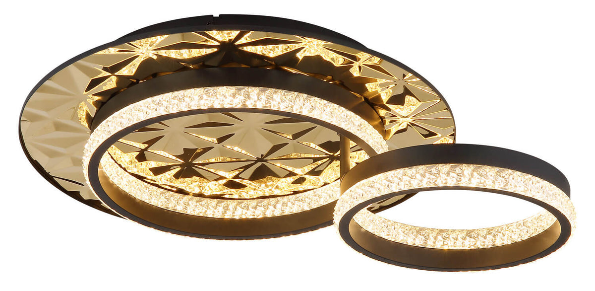 Vue rapprochée du luminaire allumé, montrant les anneaux concentriques et la lumière chaude.