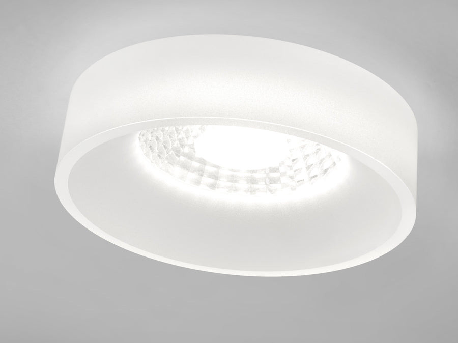 Vue rapprochée du plafonnier blanc vu de dessous, diffusant une lumière uniforme