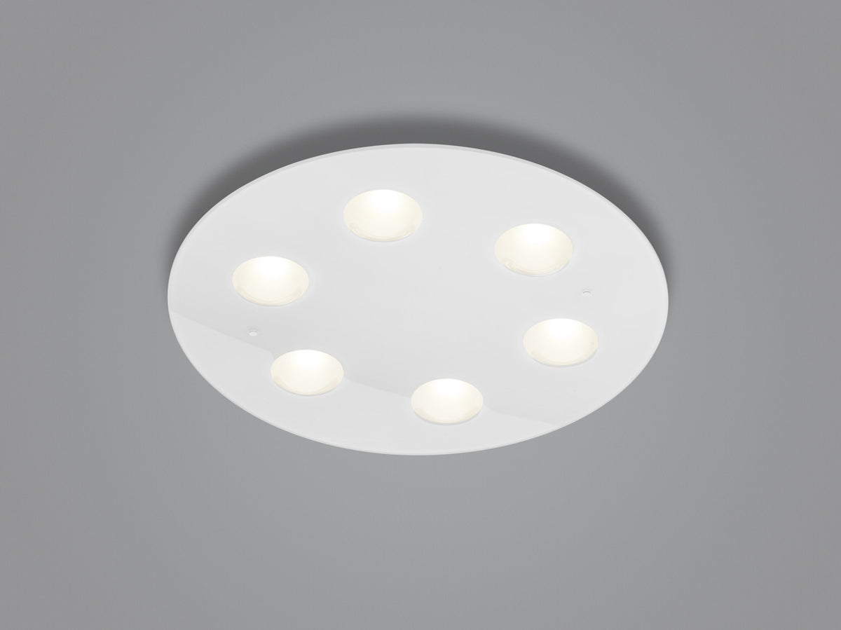 Vue de face d'un plafonnier rond blanc avec six petits spots lumineux