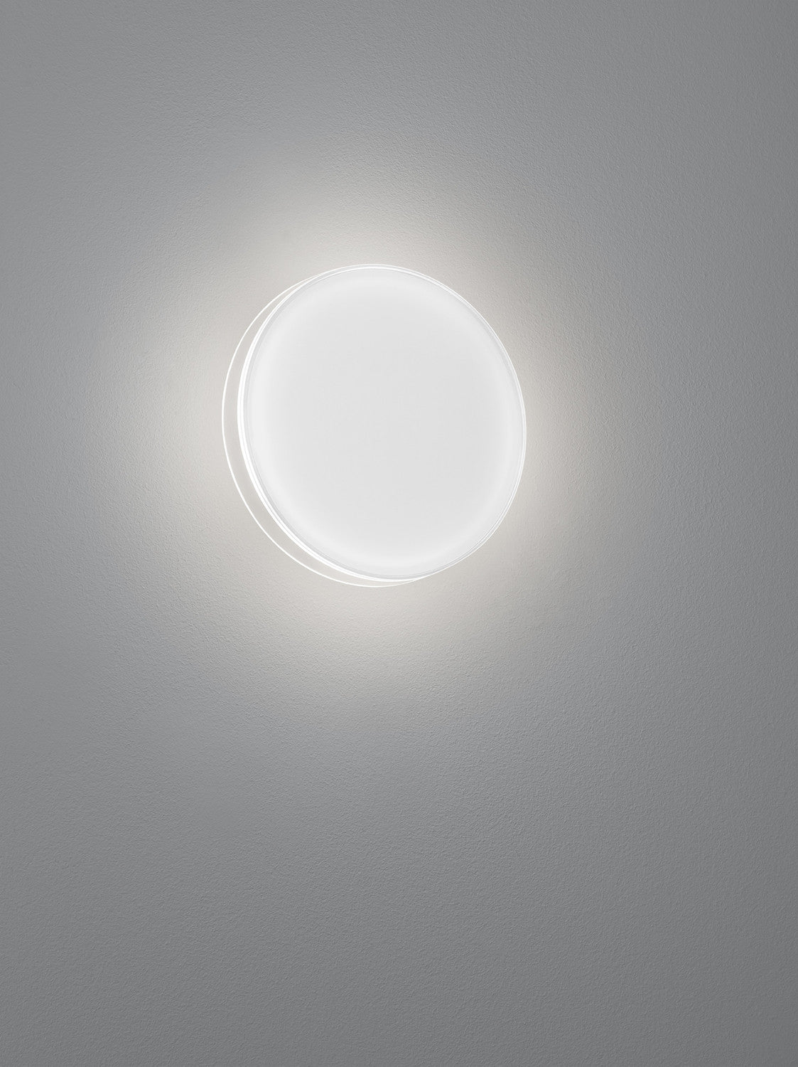 Gros plan de l applique circulaire blanche, halo lumineux diffus sur le mur
