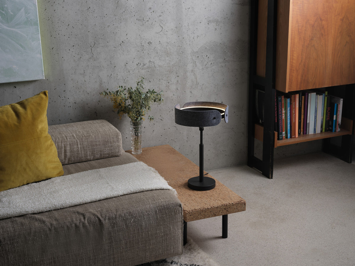 Mise en ambiance : lampe posée sur une table basse en liège près d'un canapé