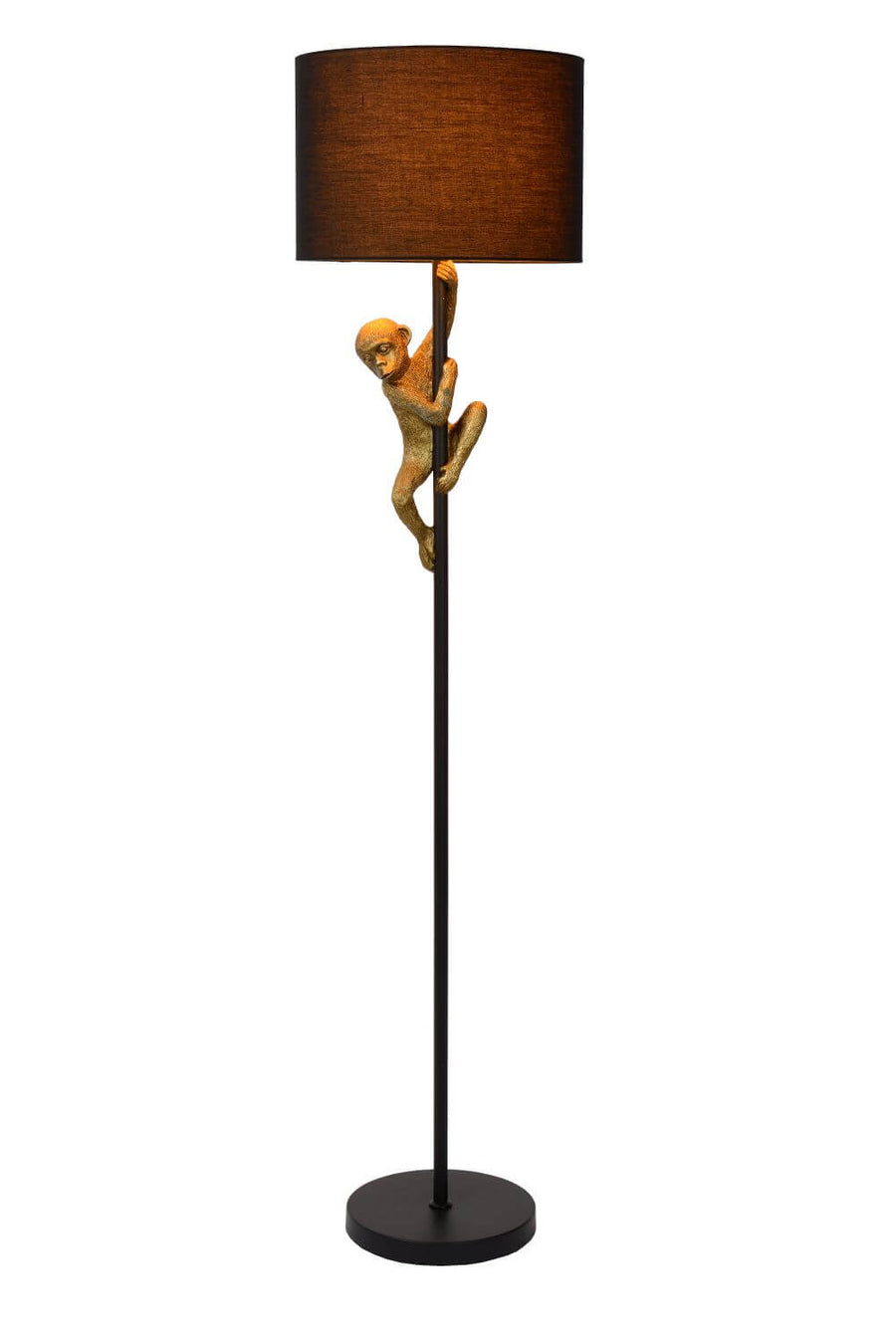 Lampadaire sur fond blanc, abat-jour cylindrique noir et singe doré grimpant