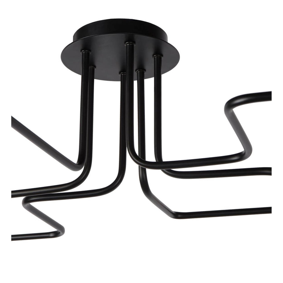 Détail du socle rond noir et des tubes coudés partant vers les douilles