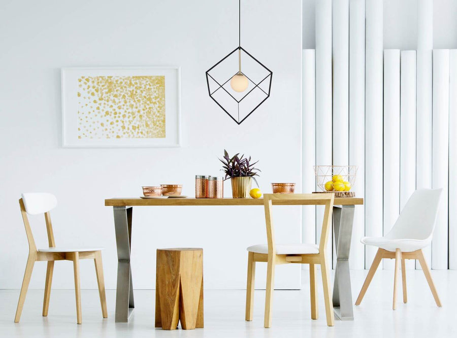 Suspension installée au-dessus d'une table de salle à manger dans un intérieur moderne et lumineux.
