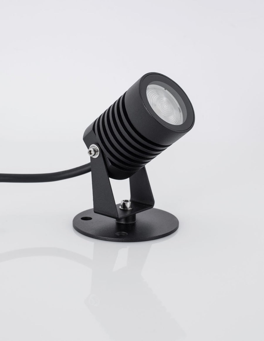 Projecteur noir de trois quarts, câble d'alimentation sortant à l'arrière