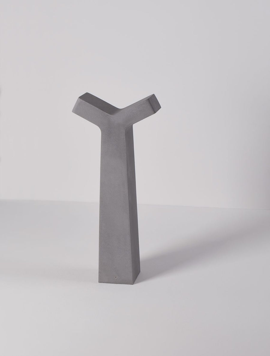 Autre angle de vue du luminaire avec ombre portée sur fond gris clair.