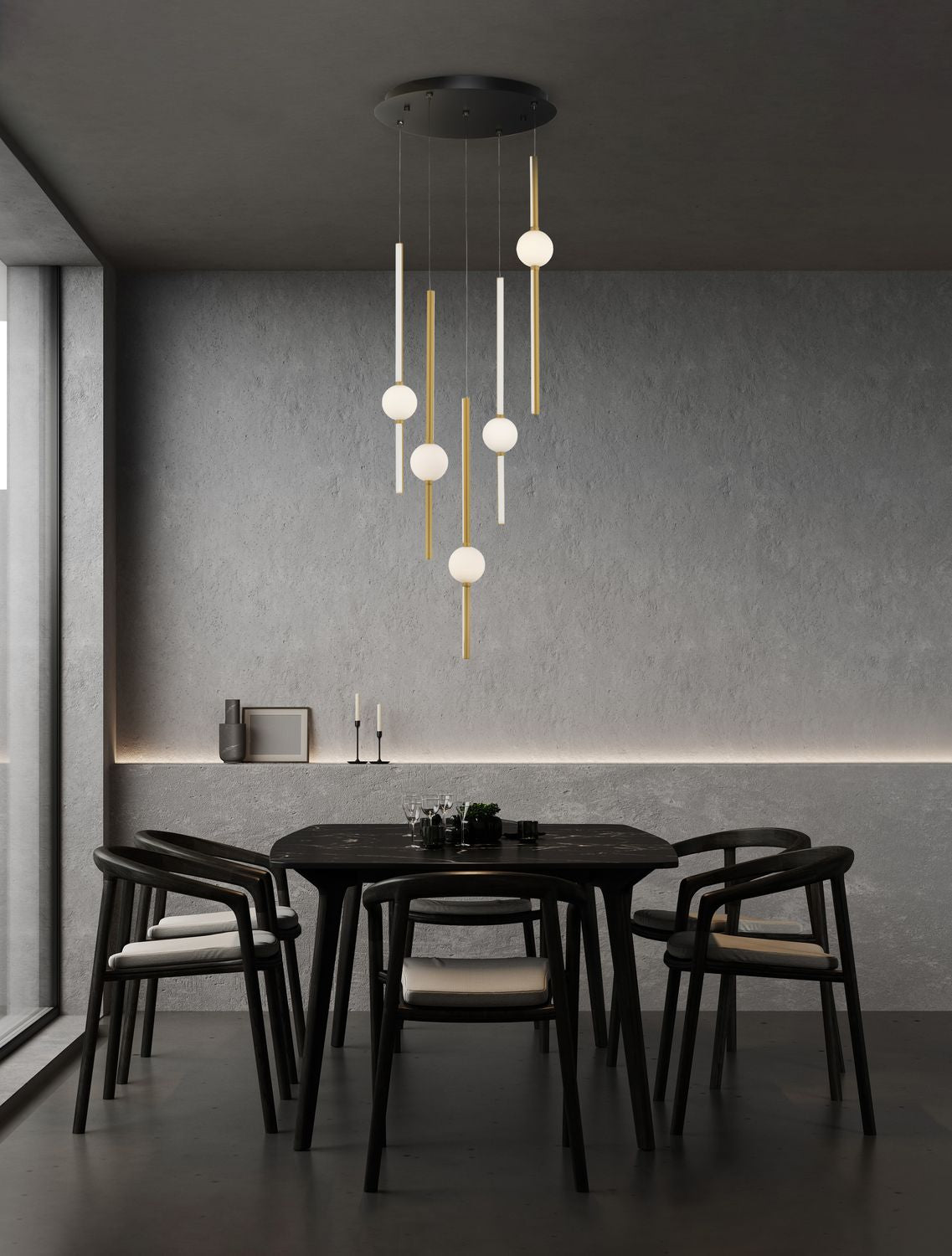 Suspension dorée allumée au-dessus d'une table à manger sombre dans un intérieur béton
