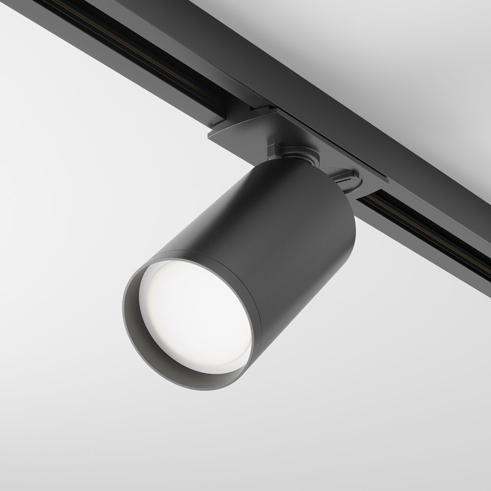Spot cylindrique noir mat fixé sur rail, vu de trois quarts