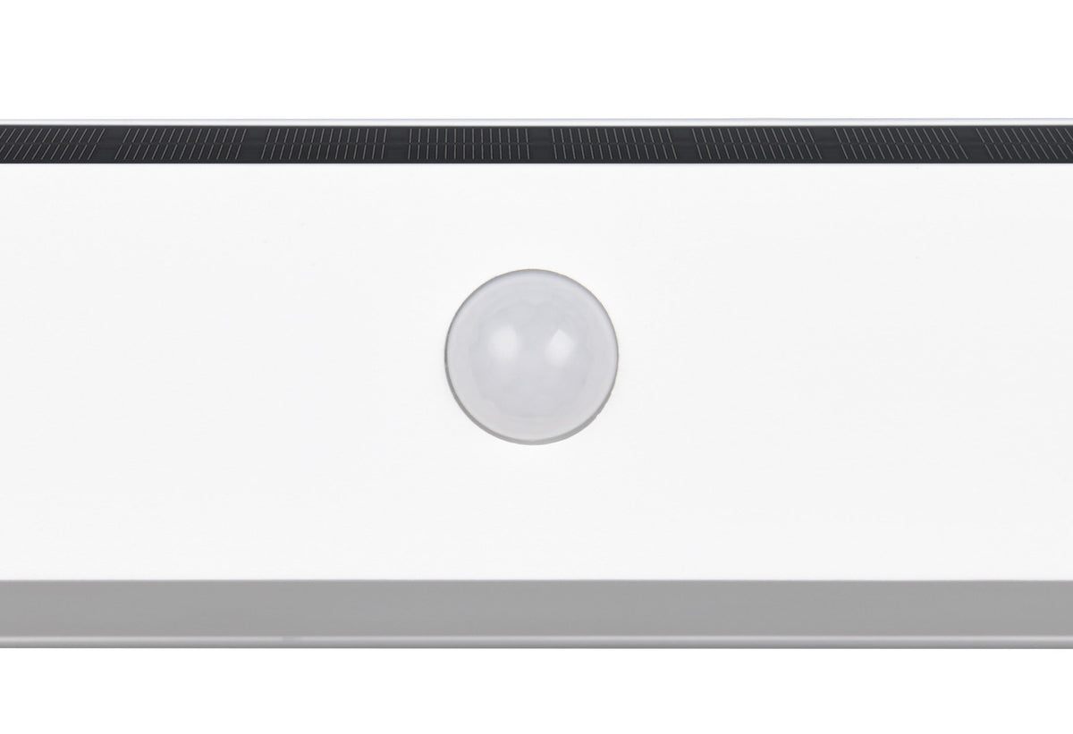 Gros plan sur la bille détectrice de mouvement et la grille noire de l'applique.