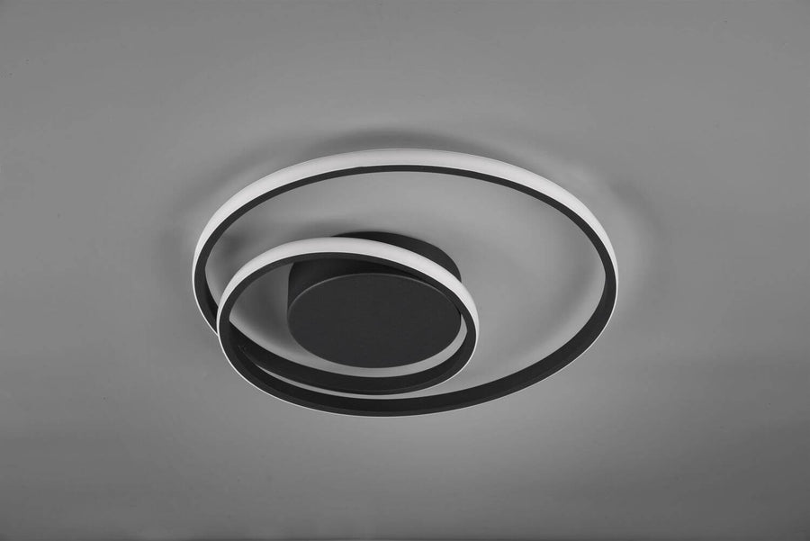 Vue de dessus montrant le socle central noir et l'emboîtement des anneaux