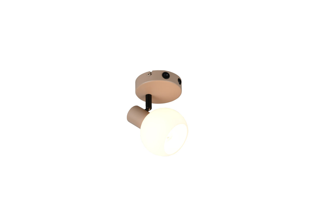 Vue de dessous du spot installé au plafond avec base ronde beige.