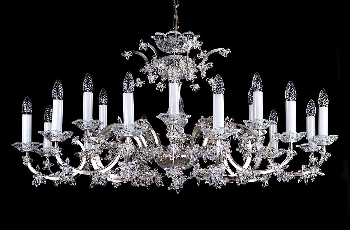 Lustre en cristal vu de face, bras à bougies blanches sur fond noir
