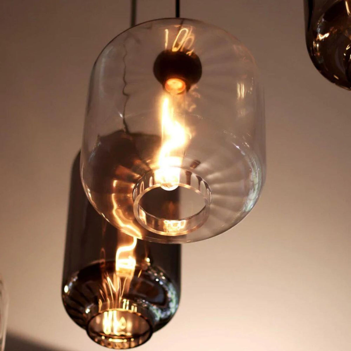 Gros plan sur l'abat-jour en verre transparent à côtes et l'ampoule allumée
