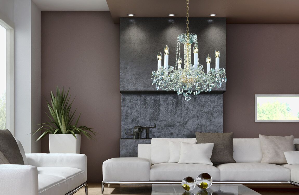 Mise en ambiance dans un salon moderne, lustre suspendu au-dessus d'un canapé blanc et mur sombre.