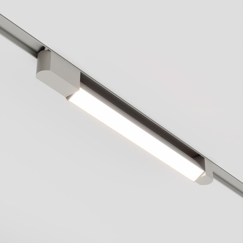 Luminaire blanc linéaire fixé sur rail, face avant allumée en lumière blanche