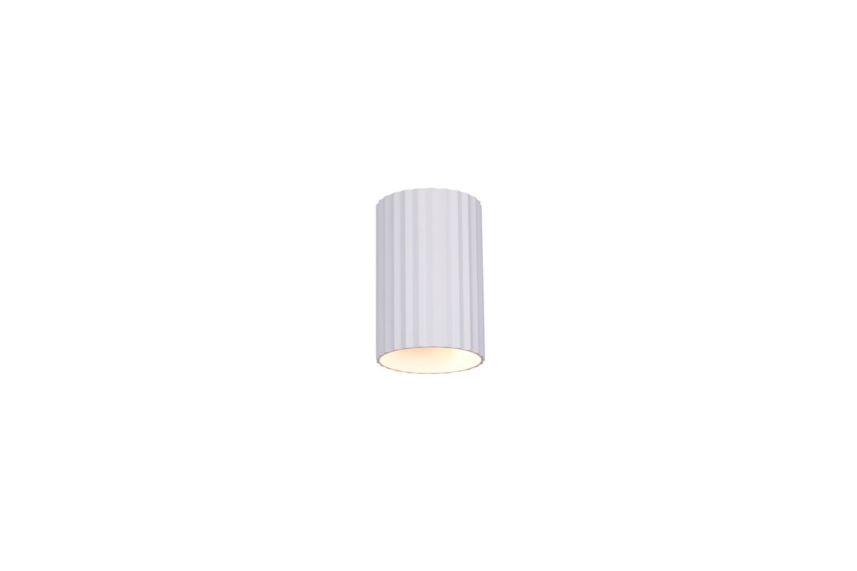 Applique cylindrique blanche mate, lumière chaude visible sous la base