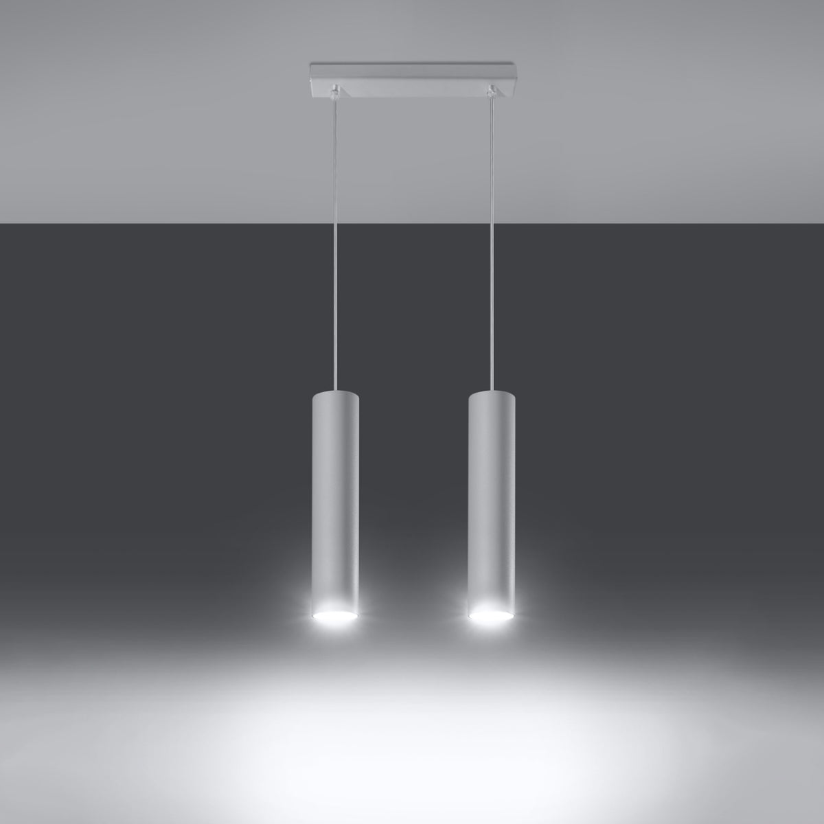 Mise en ambiance sombre, les deux cylindres diffusent un faisceau lumineux vers le bas.