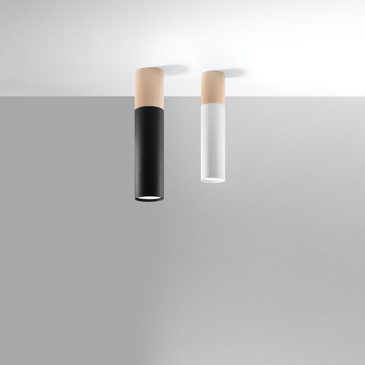 Deux plafonniers cylindriques côte à côte, un noir et un blanc.