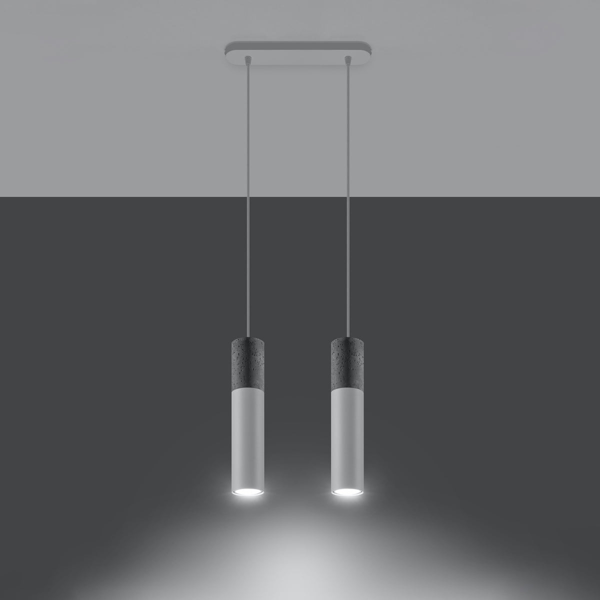 Mise en ambiance sombre montrant les deux cylindres allumés diffusant une lumière blanche