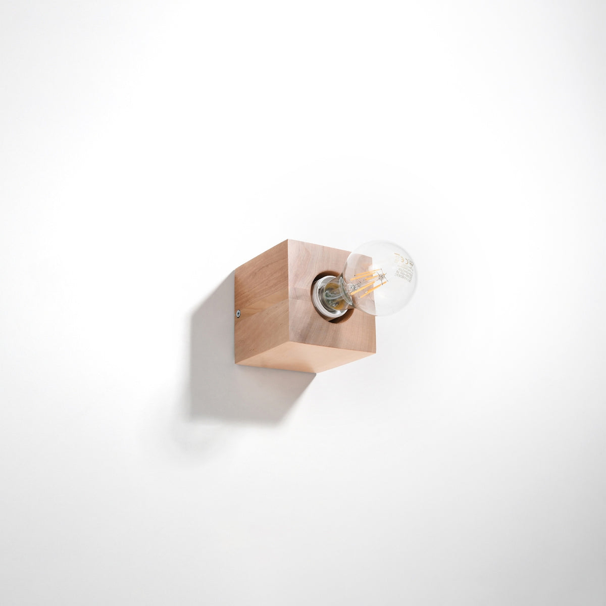 Bloc de bois cubique fixé sur un mur blanc, ombre portée nette, éclairage neutre