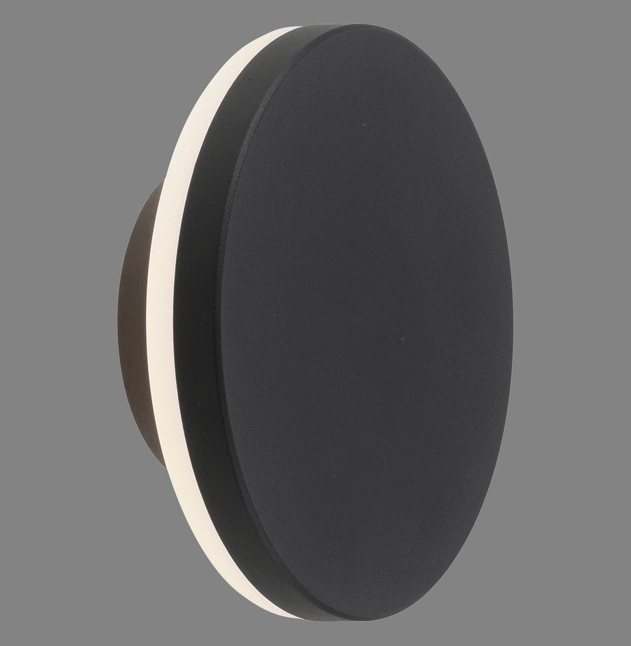 Applique murale ronde anthracite vue de profil sur fond gris, diffuseur blanc visible.