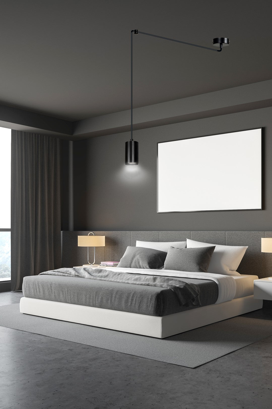 Mise en ambiance dans une chambre grise, suspension noire au-dessus du lit.