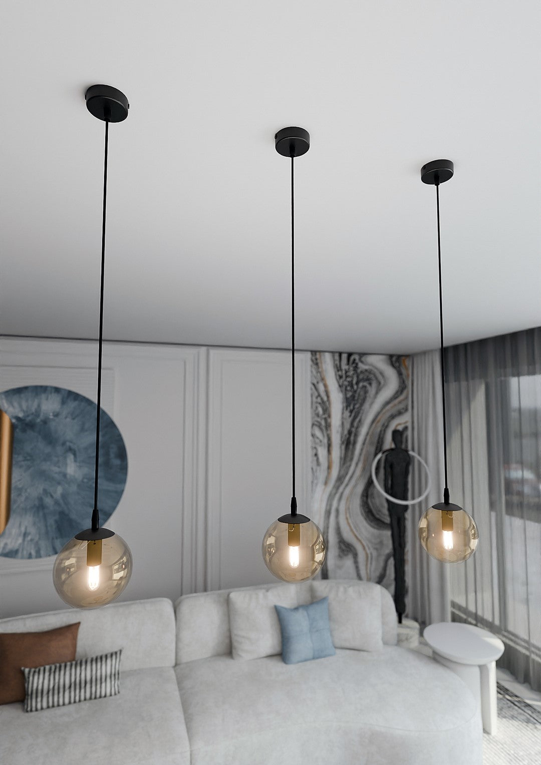 Vue en plongée de trois globes suspendus dans un salon moderne