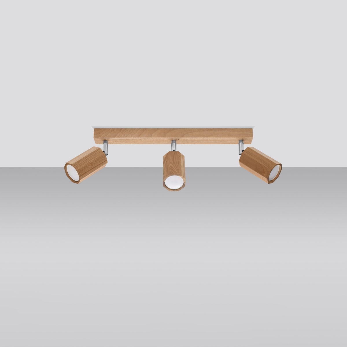 Vue de face sur fond gris, projecteurs orientables et barre rectangulaire en bois.