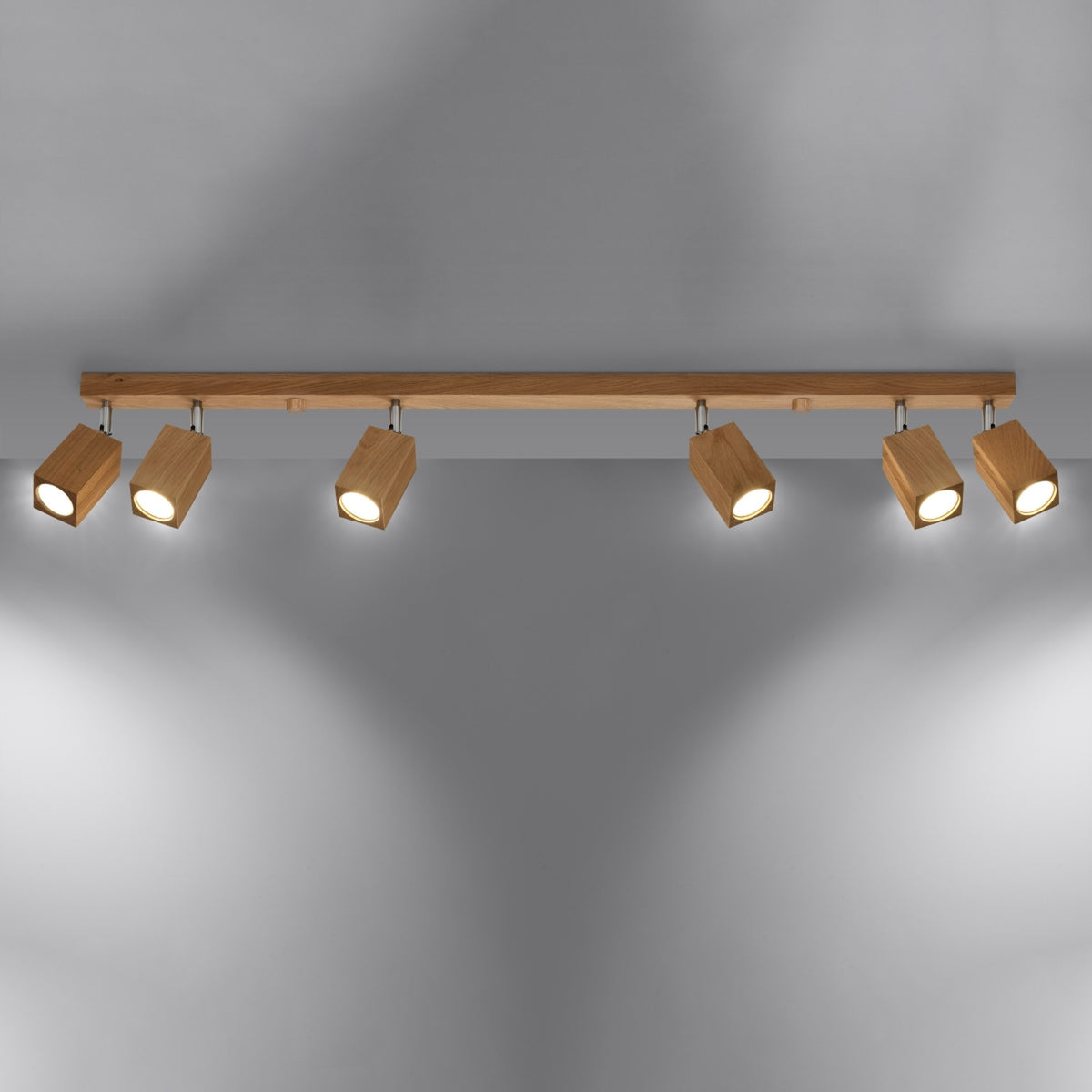 Plafonnier allumé dans une ambiance sombre, six spots orientables diffusent une lumière chaude.