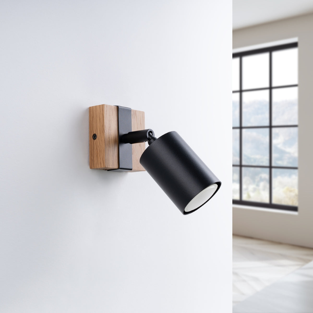 Applique installée sur un mur blanc près d'une fenêtre, éclairage éteint