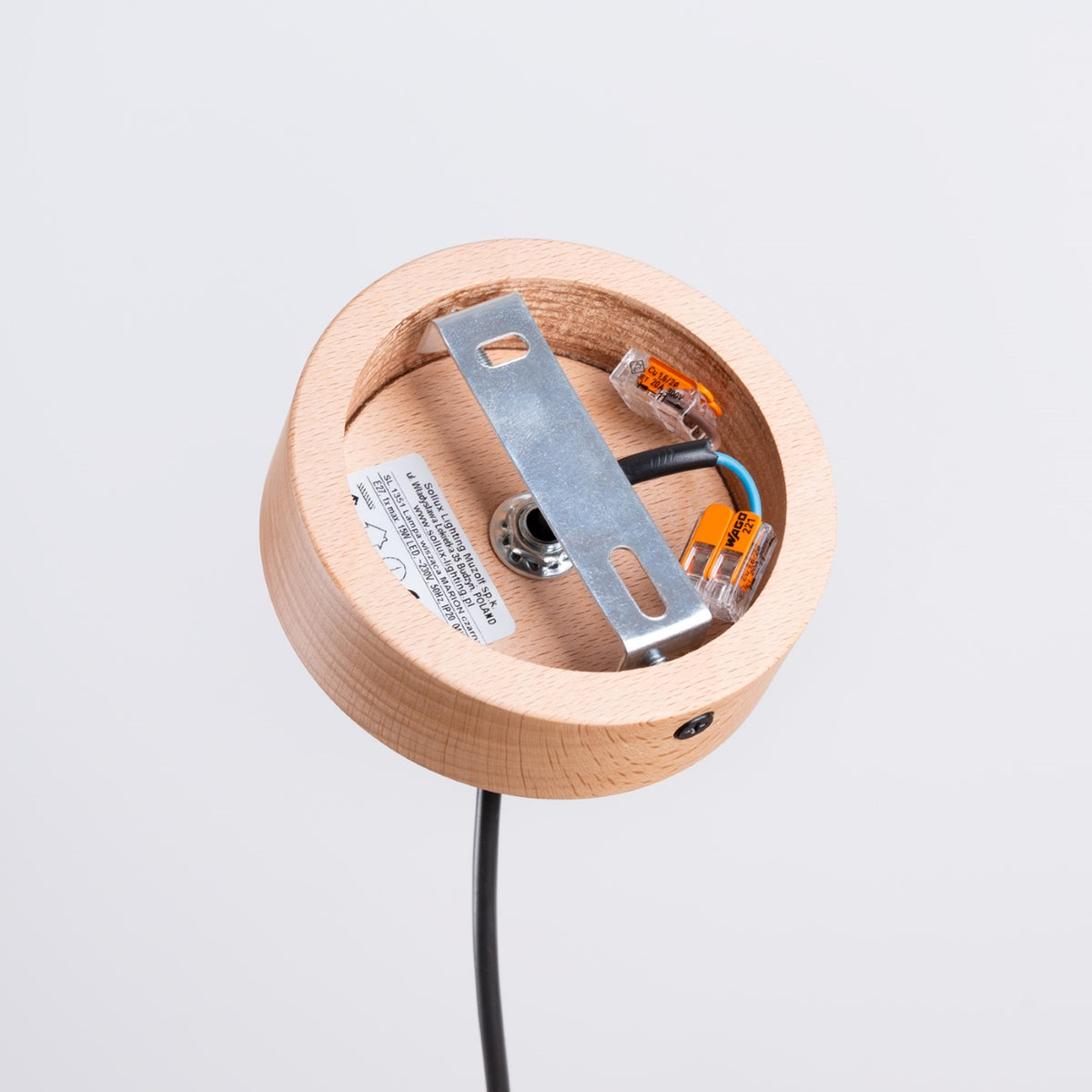 Détail du support plafond en bois, câblage et connecteurs électriques visibles.